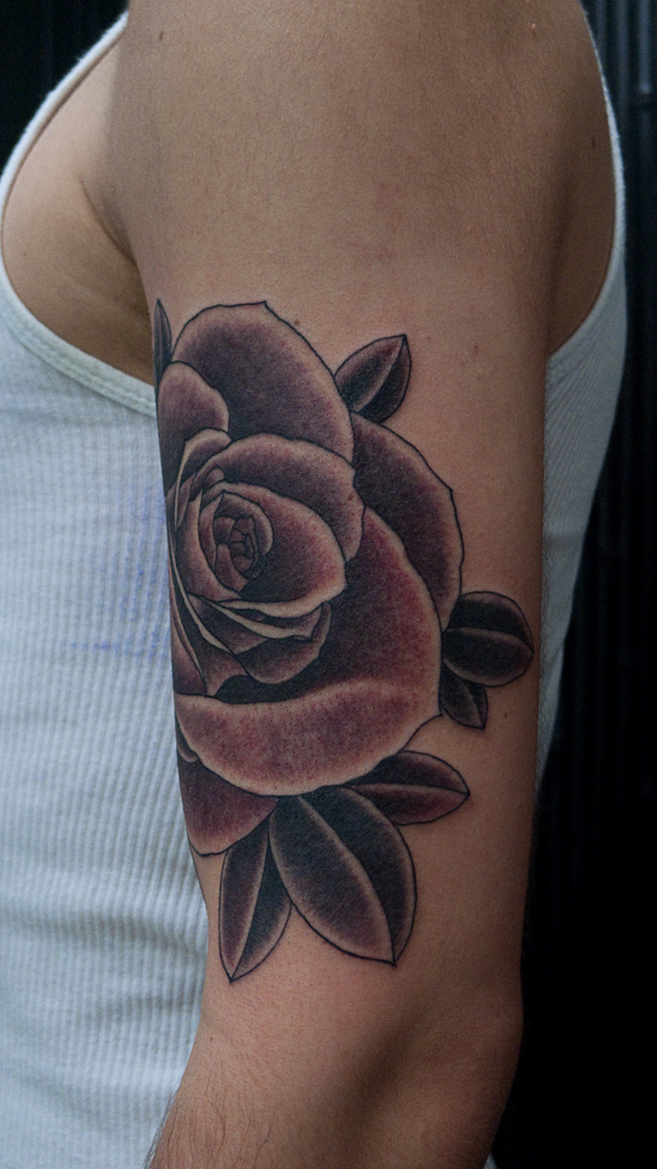 Just a plain old simple rose tattoo not bad for the guys first tattoo as